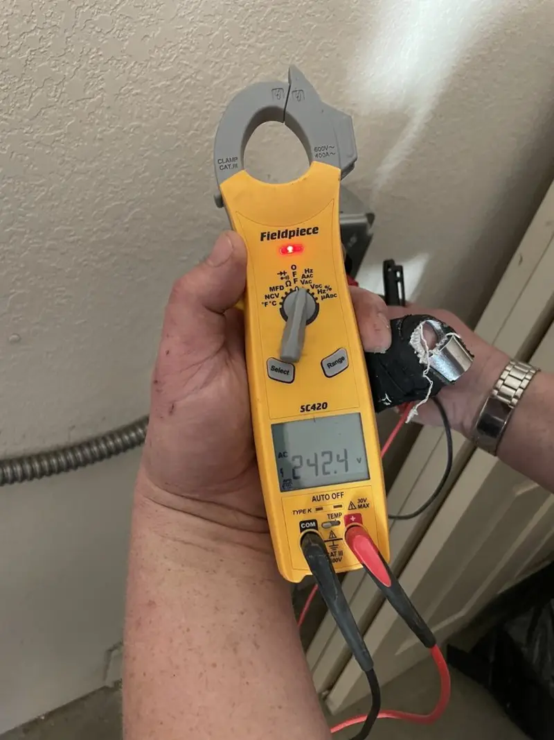 Voltage testing with clamp meter during Generator Installation in Taylor Creek